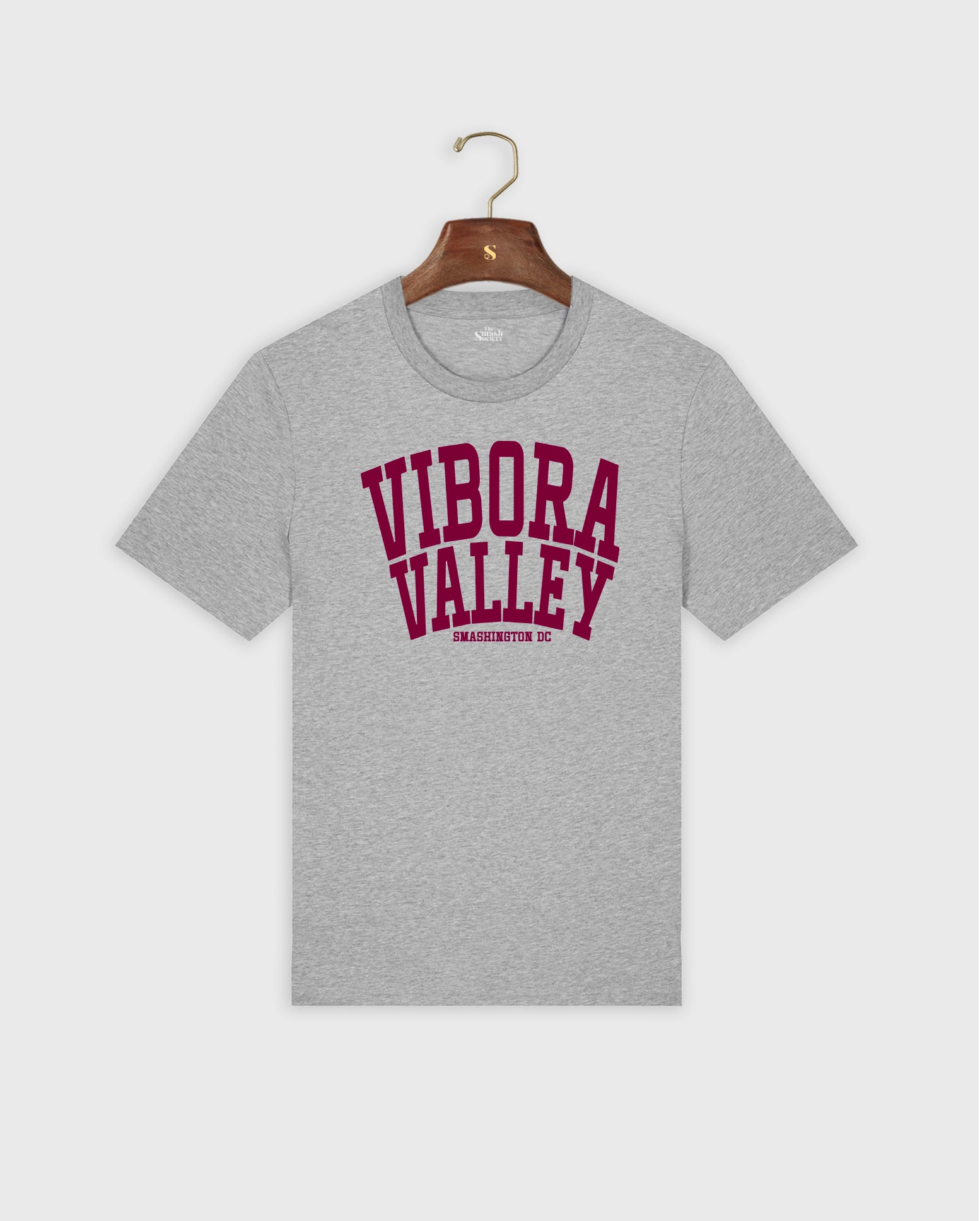 Gray padel t-shirt with 'Vibora Valley' text on a hanger against a white background