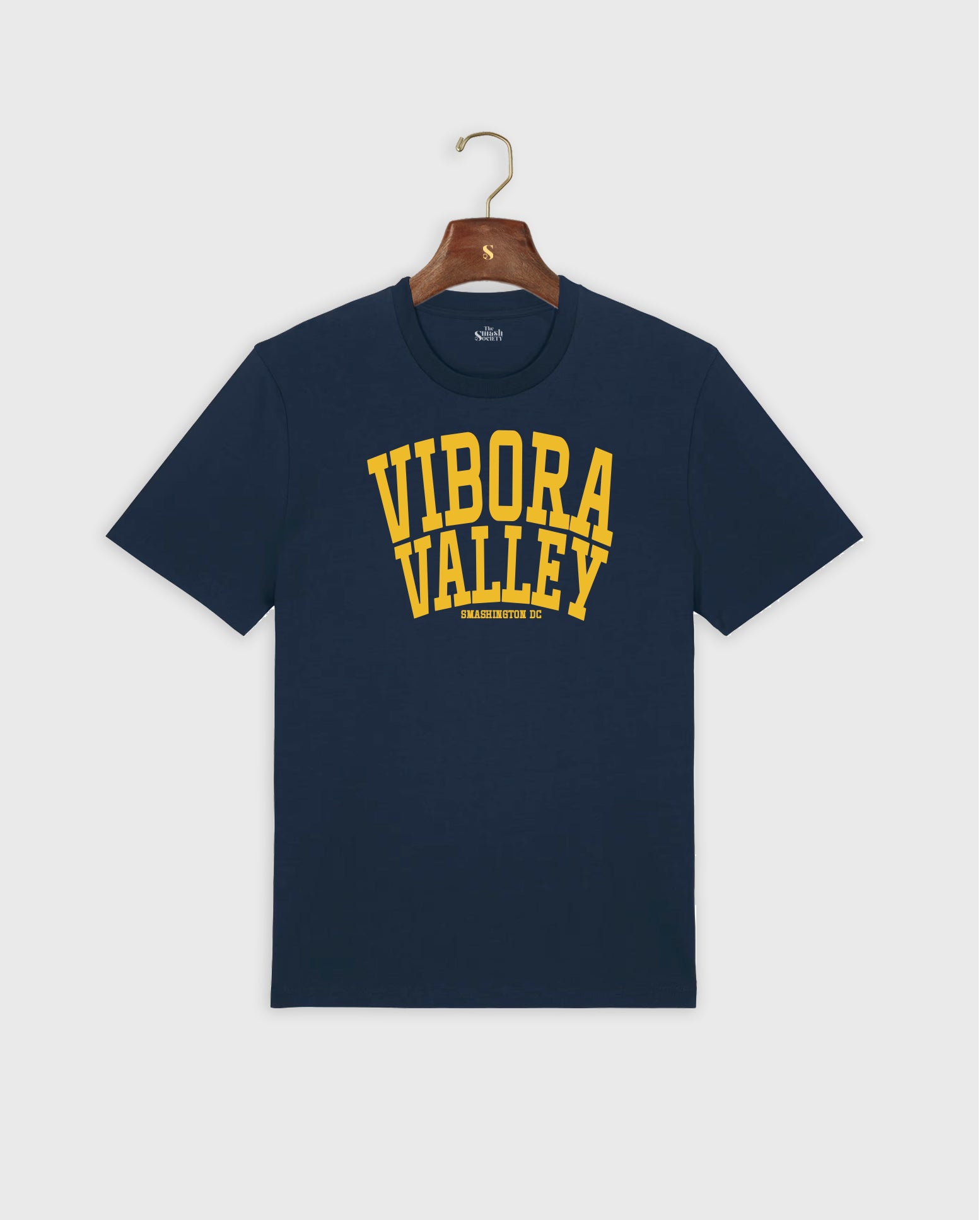 Navy blue padel t-shirt with 'Vibora Valley' text in yellow on a hanger against a white background