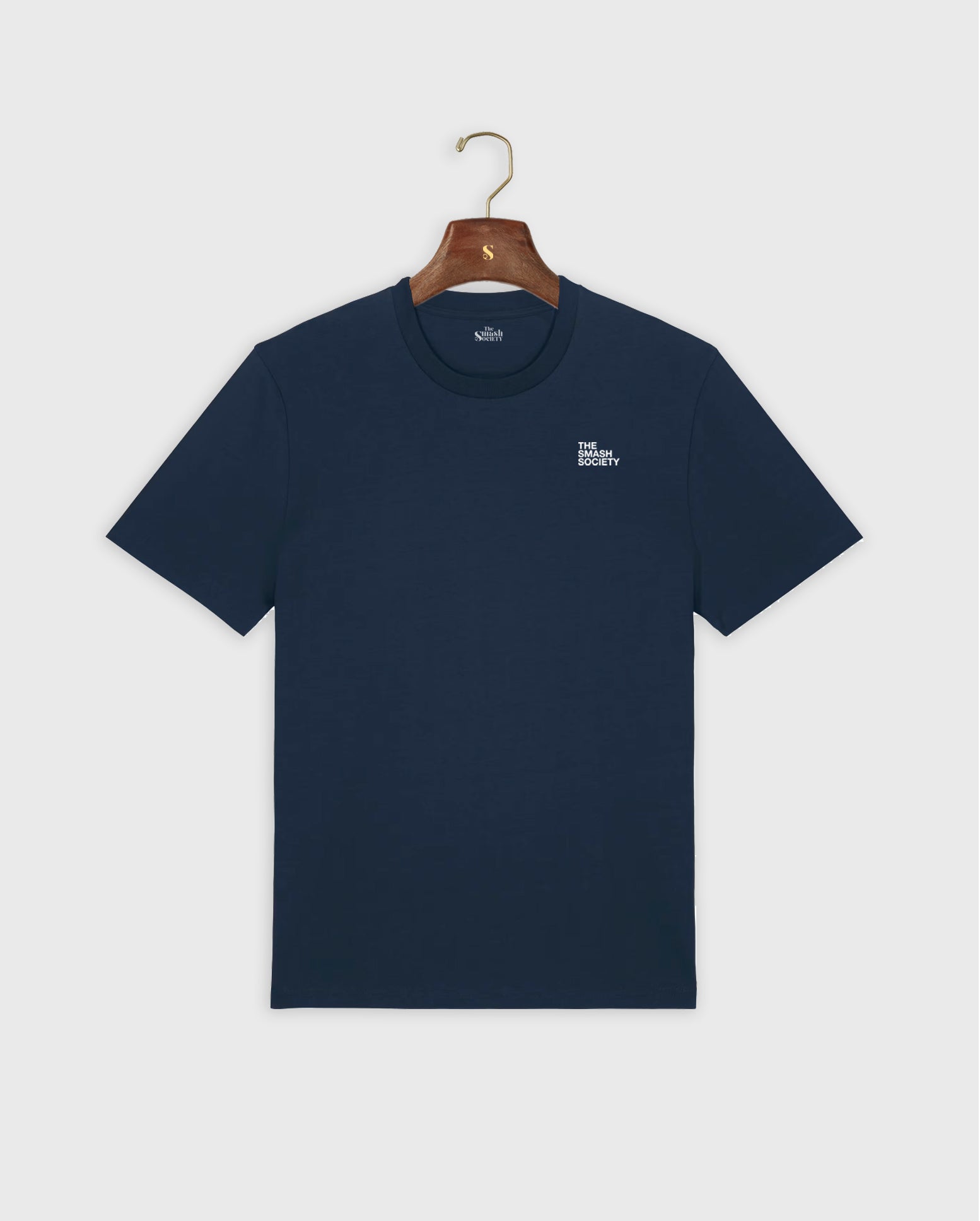 Navy padel t-shirt with a small the smash society logo on a hanger against a white background