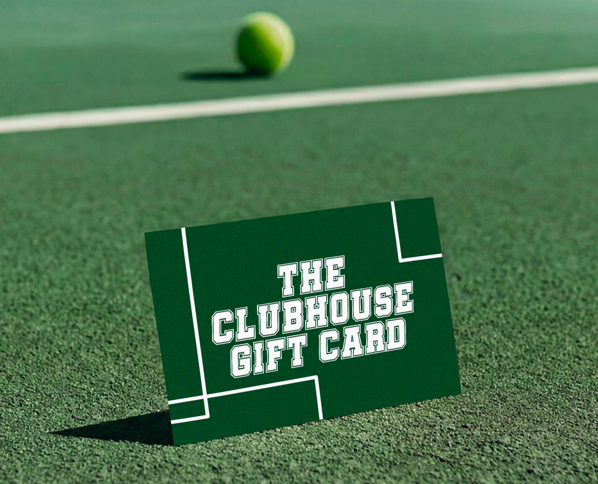Green gift card with 'The Clubhouse Gift Card' text on a padel court with a ball in the background.