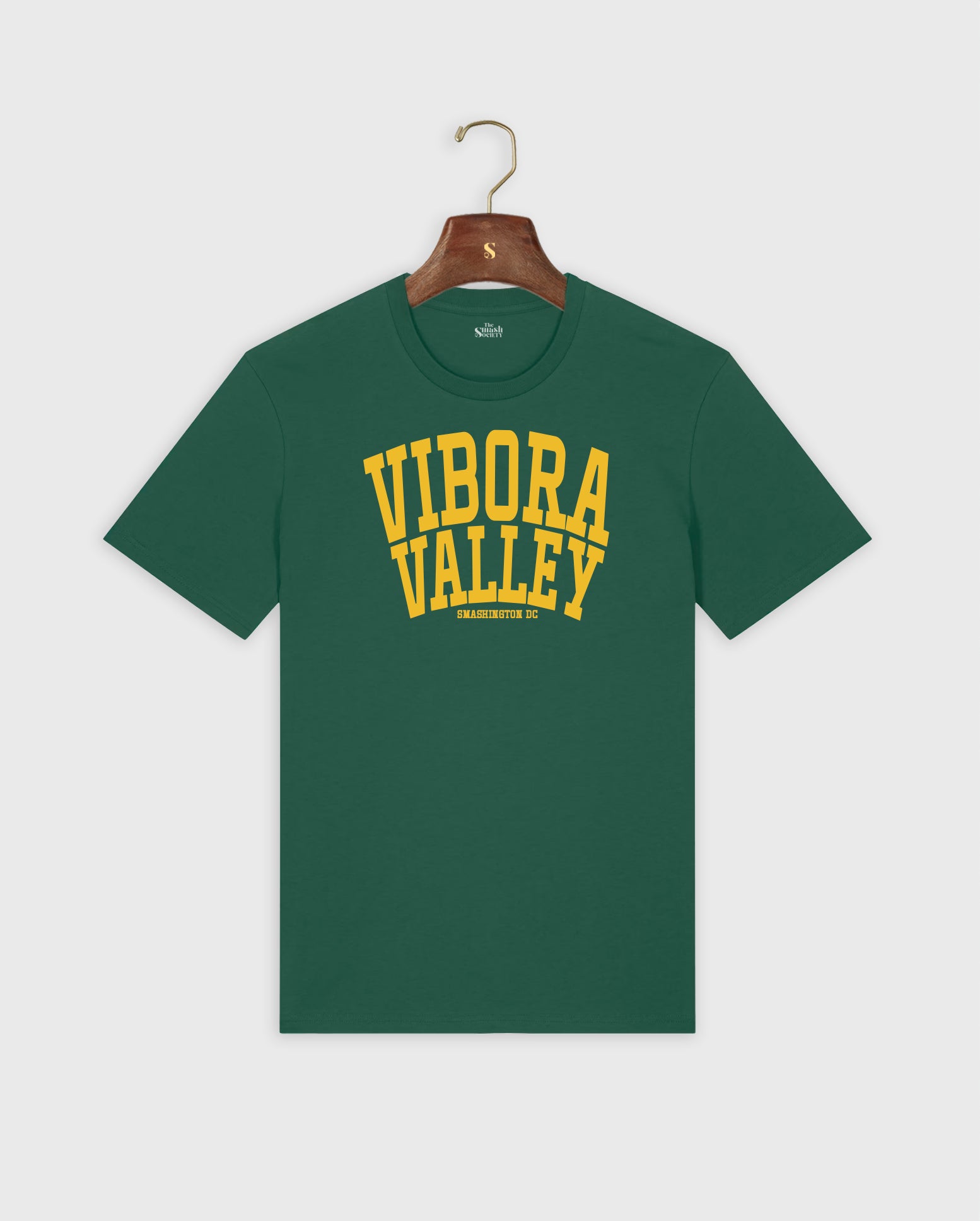 Green padel t-shirt with 'Vibora Valley' text on a hanger against a white background