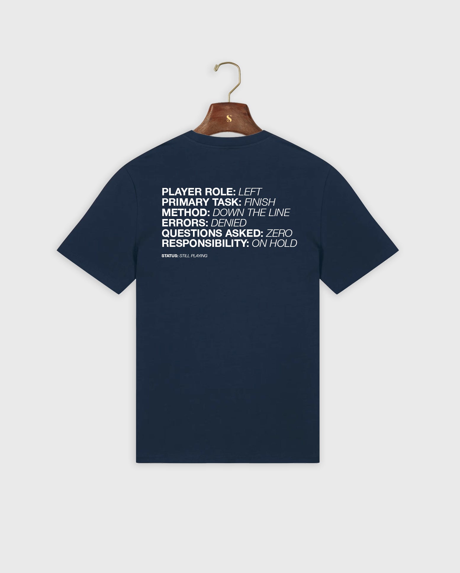 Navy blue padel t-shirt with white text on a hanger against a light gray background