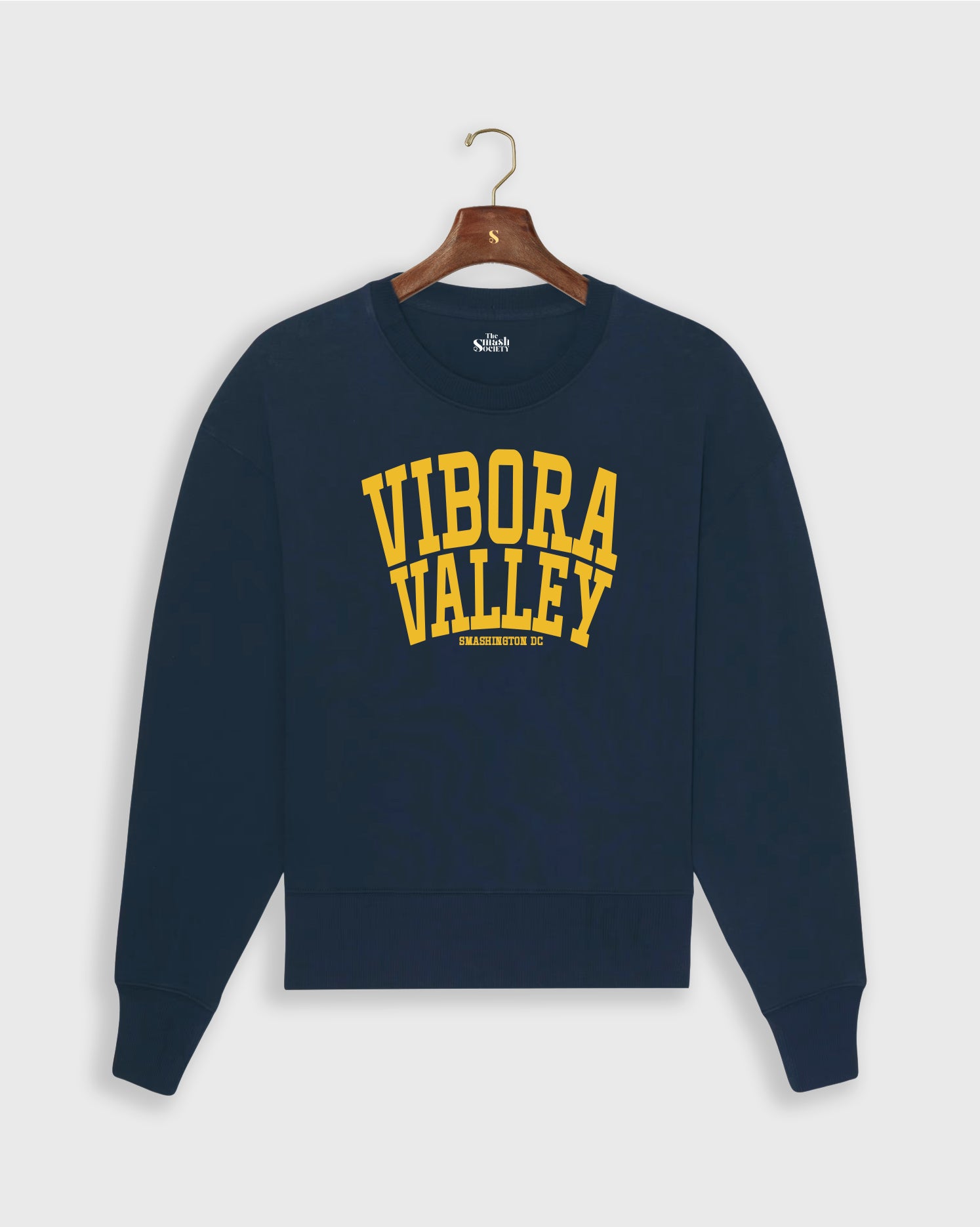 Navy blue padel sweatshirt with 'Vibora Valley' text on a hanger against a white background